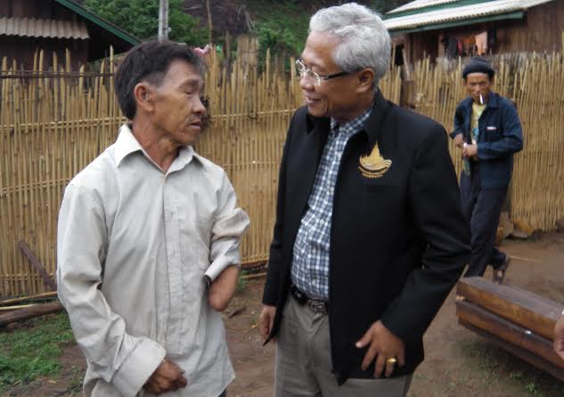 Dr. Khamphet, the Director of the Center for Medical Rehabilitation (CMR), speaks with a UXO survivor and amputee. The CMR is the primary provider of physical therapy and prosthetics in Laos.