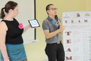 Lao IT development worker demonstrates the new app for persons with autism