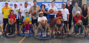 us ambassador, TEAM project, and wheelchair basketball participants stand together for group photo