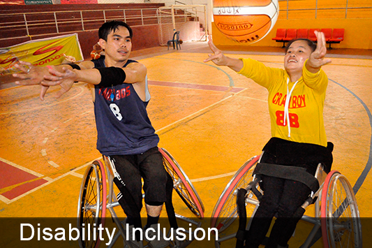 Disability Inclusion - two youths play wheelchair basketball