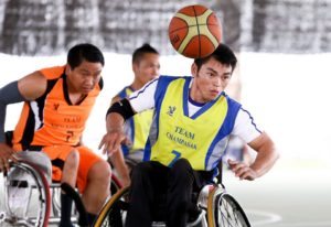 wheelchair basketball player chases basketball